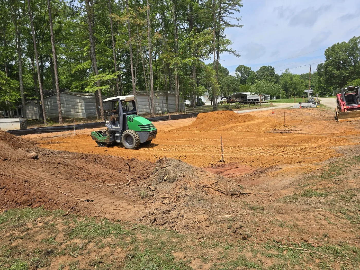 Compactor rolling a freshly graded building pad